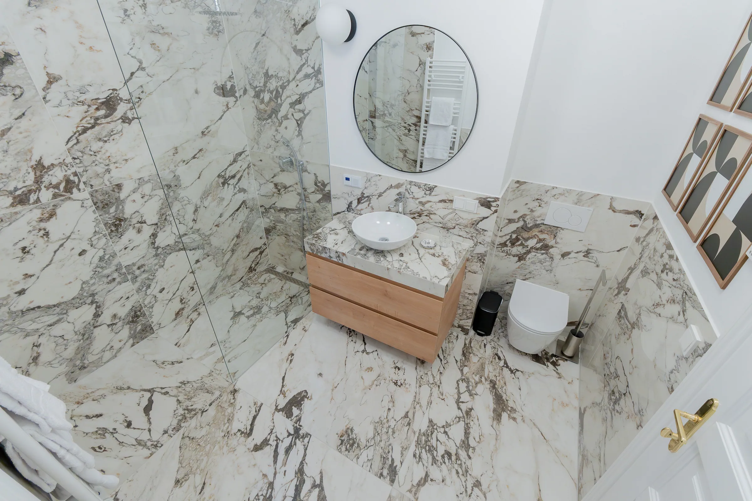 Zweites Badezimmer der Altbauwohnung mit Naturstein und Holzelementen