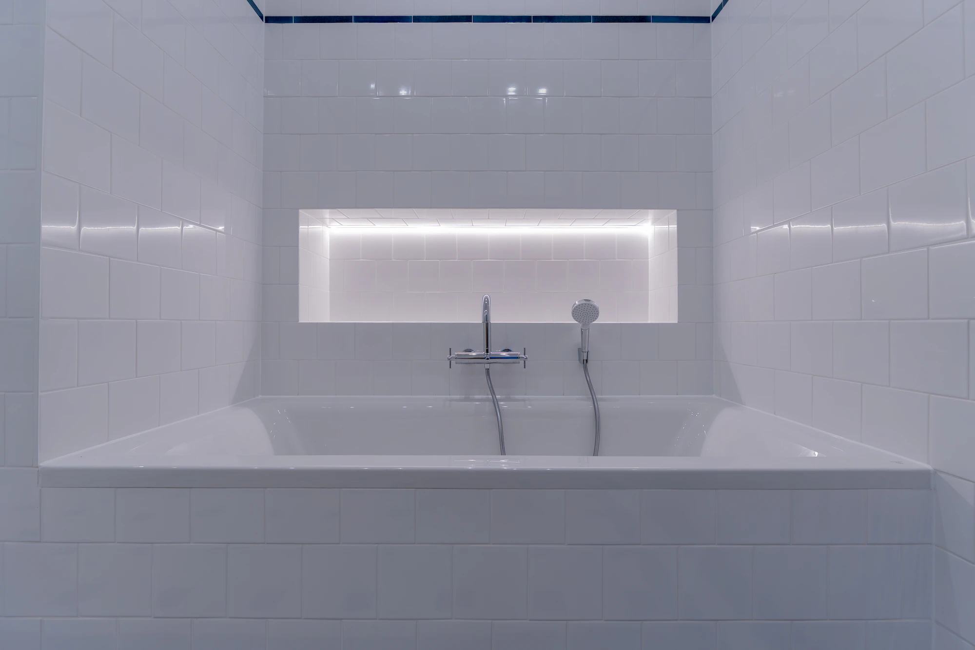 Badewanne mit integrierter Beleuchtung in einem sanierten Badezimmer